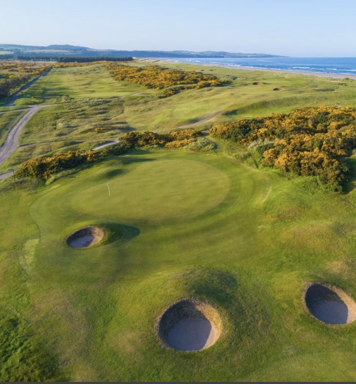 Aerial view of a links course by the sea